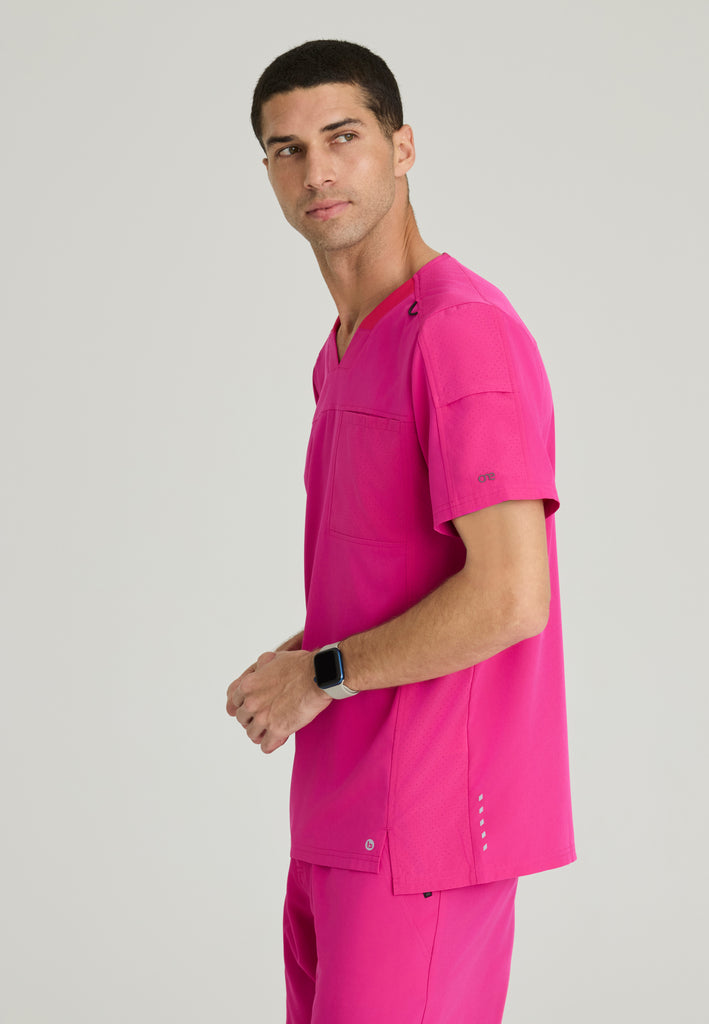 Side View of the Velocity 2-Pocket V-Neck Scrub Top in Pink from Barco One